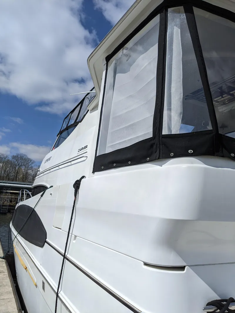 Slide: The Image of 2001 Carver 466 Motor Yacht docked under a clear blue sky. - 2