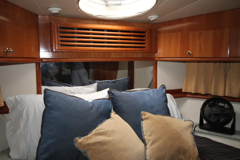 Slide: The Image of Cozy bedroom in 2001 Carver 466 Motor Yacht with plush pillows and wooden cabinetry. - 20