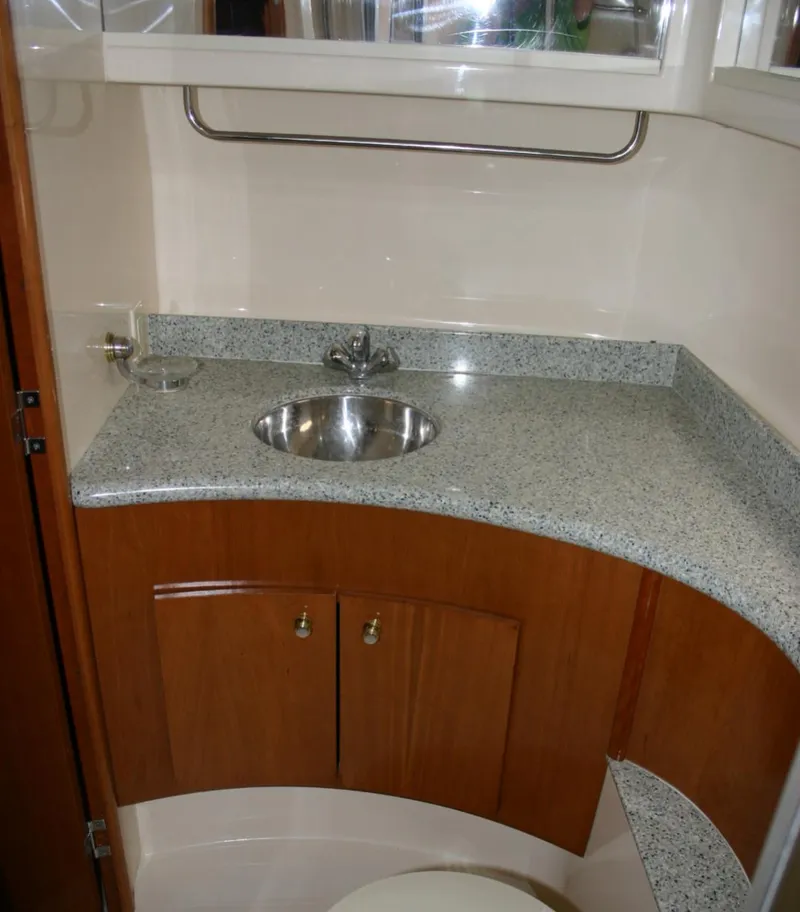 Slide: The Image of 2001 Carver 466 Motor Yacht bathroom with granite countertop and stainless steel sink. - 21