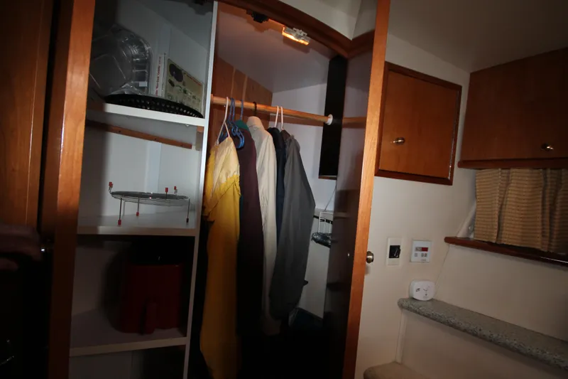 Slide: The Image of Closet interior of 2001 Carver 466 Motor Yacht with hanging clothes and shelves. - 24