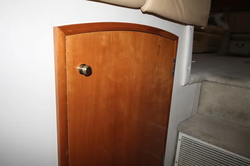 Slide: The Image of Wooden cabinet door on 2001 Carver 466 Motor Yacht interior, near carpeted stairs. - 27