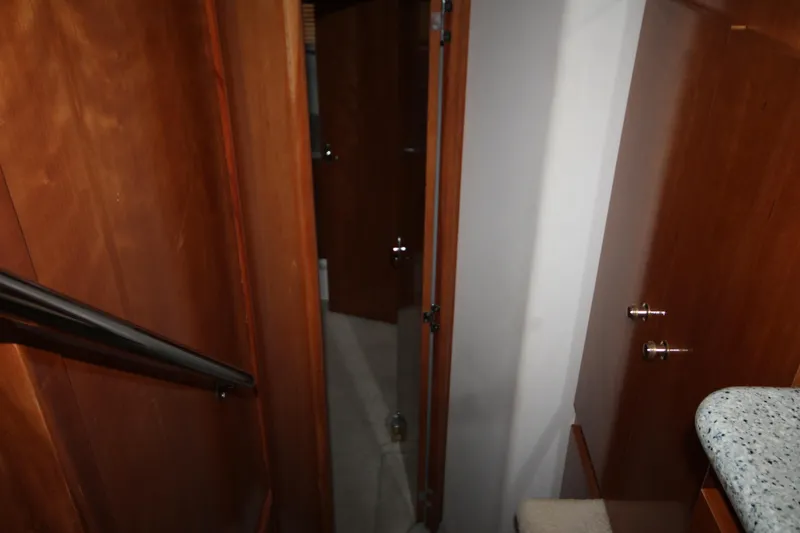 Slide: The Image of 2001 Carver 466 Motor Yacht interior hallway with wooden doors and carpeted floor. - 30