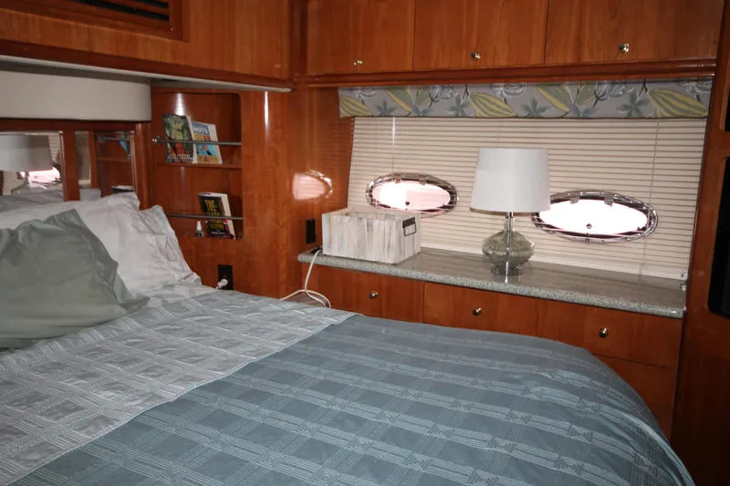 Slide: The Image of Interior cabin of 2001 Carver 466 Motor Yacht with bed, lamp, and porthole windows. - 31