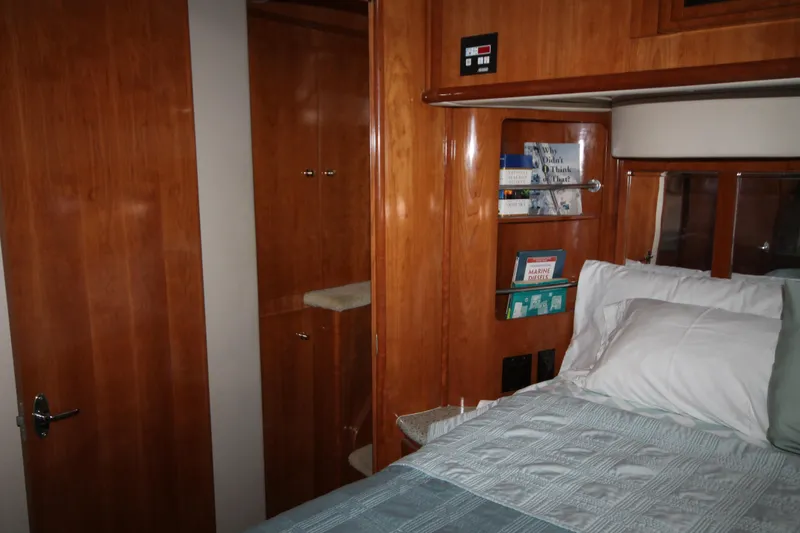 Slide: The Image of Interior cabin of 2001 Carver 466 Motor Yacht with wooden finishes and bed. - 32