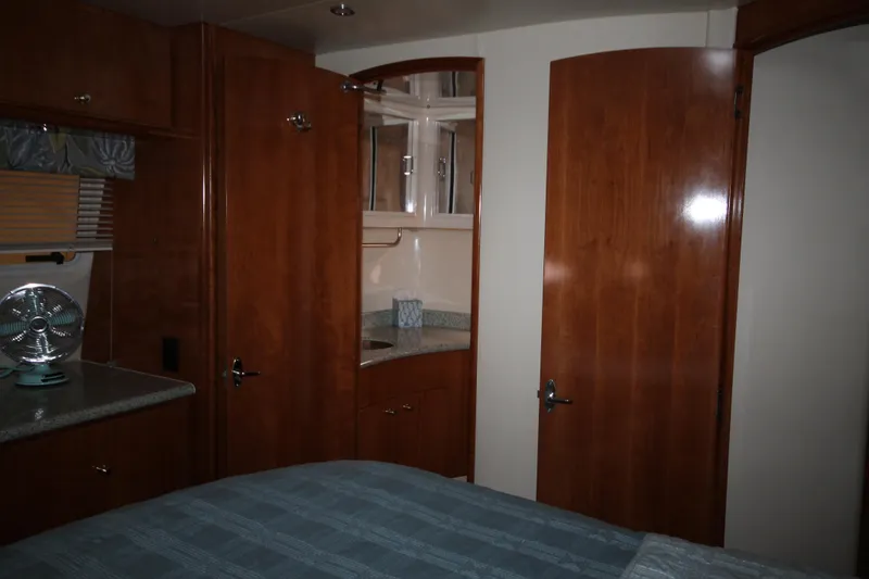 Slide: The Image of Interior cabin of 2001 Carver 466 Motor Yacht with wooden cabinetry and bed. - 33