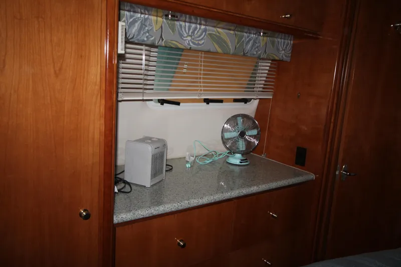 Slide: The Image of Interior of 2001 Carver 466 Motor Yacht with wooden cabinetry and countertop fan. - 35