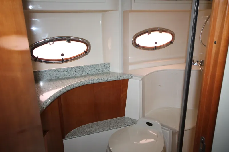 Slide: The Image of 2001 Carver 466 Motor Yacht bathroom with granite countertop and oval windows. - 36