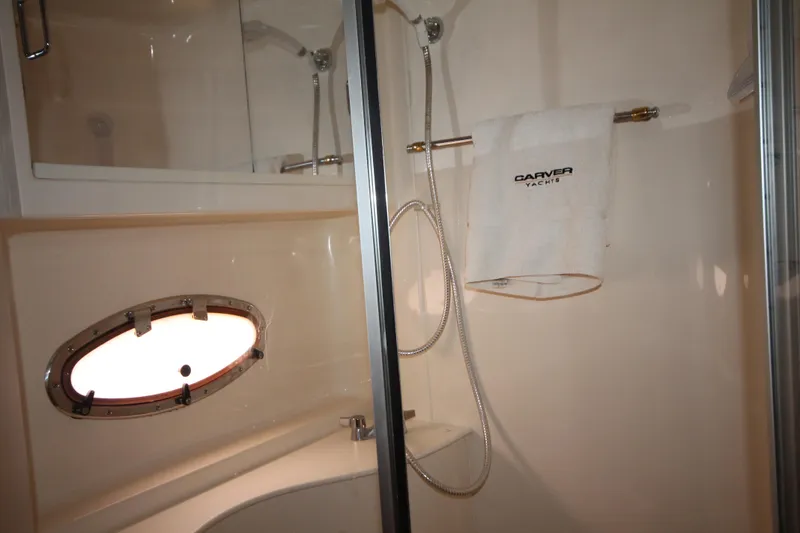 Slide: The Image of Bathroom of 2001 Carver 466 Motor Yacht with shower, towel, and porthole window. - 38