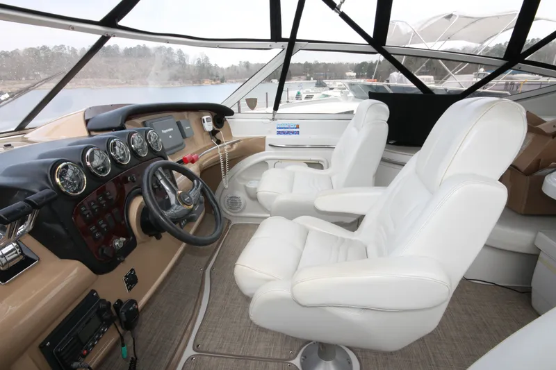 Slide: The Image of 2001 Carver 466 Motor Yacht helm with white leather seats and control panel. - 43