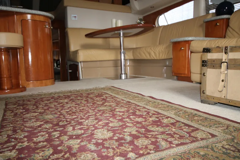 Slide: The Image of Interior of a 2001 Carver 466 Motor Yacht with a luxurious seating area and ornate rug. - 6