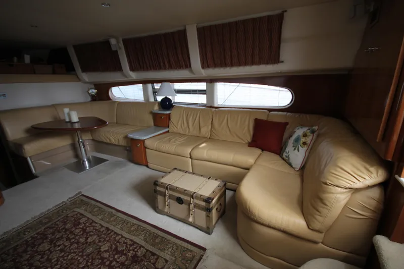 Slide: The Image of Interior of 2001 Carver 466 Motor Yacht with beige leather seating and wooden accents. - 8
