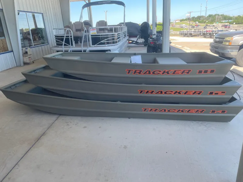 Slide: The Image of 2024 Tracker Grizzly 1236 Jon boats stacked at a dealership. - 4