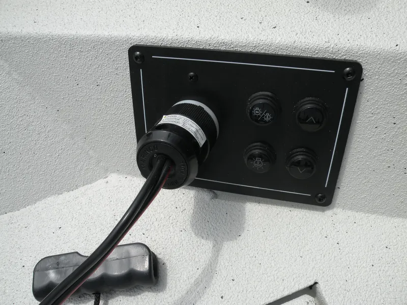 Slide: The Image of Control panel of 2024 Ranger RB210 boat with connected cables. - 11