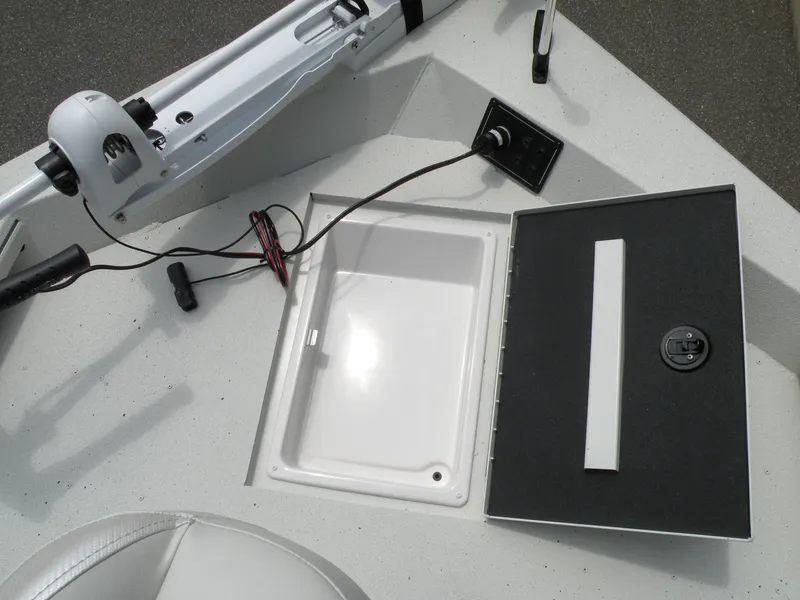 Slide: The Image of 2024 Ranger RB210 boat storage compartment and control panel. - 13