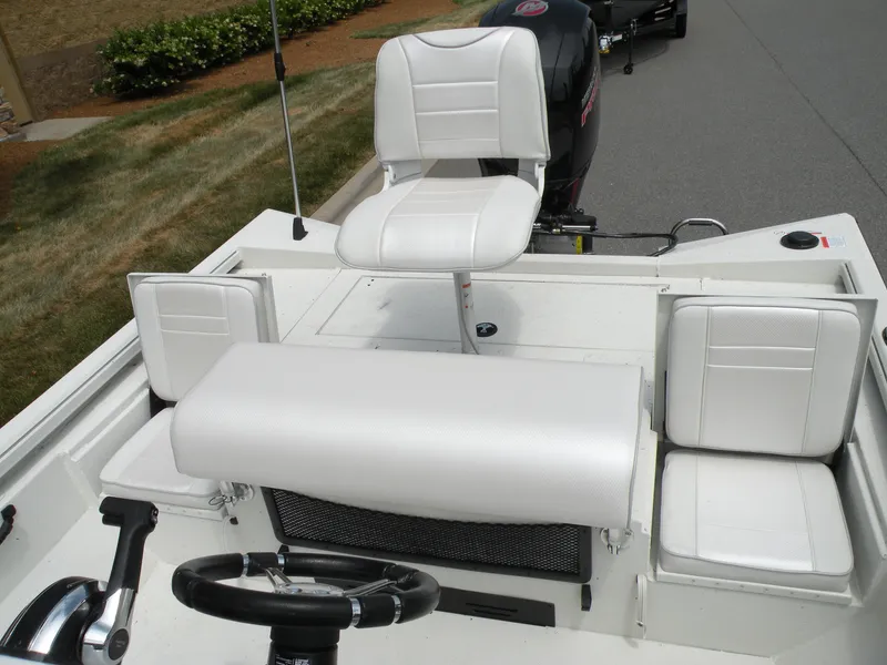Slide: The Image of 2024 Ranger RB210 boat interior with white seating and steering wheel. - 4