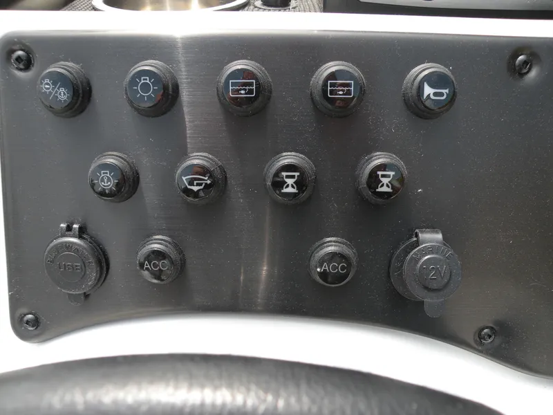 Slide: The Image of Control panel of 2024 Ranger RB210 boat with various switches and ports. - 6