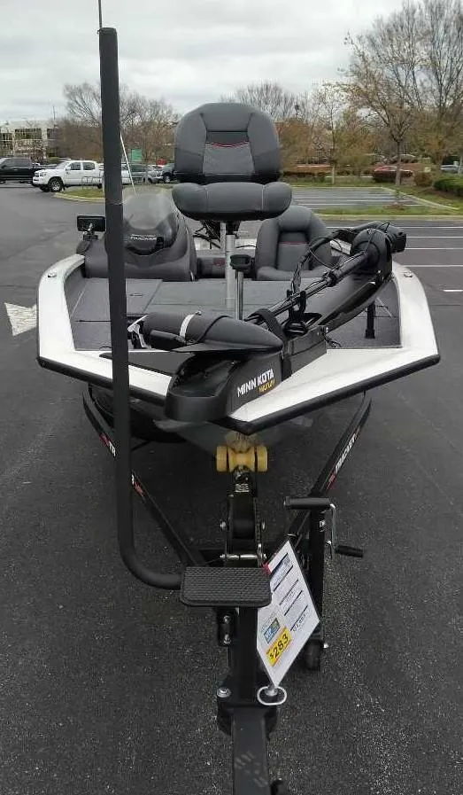 Slide: The Image of 2024 Tracker Pro Team 190 TX fishing boat on trailer in parking lot. - 2
