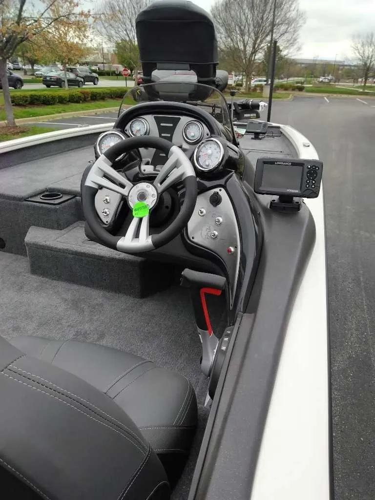 Slide: The Image of 2024 Tracker Pro Team 190 TX boat interior with steering wheel and dashboard controls. - 4