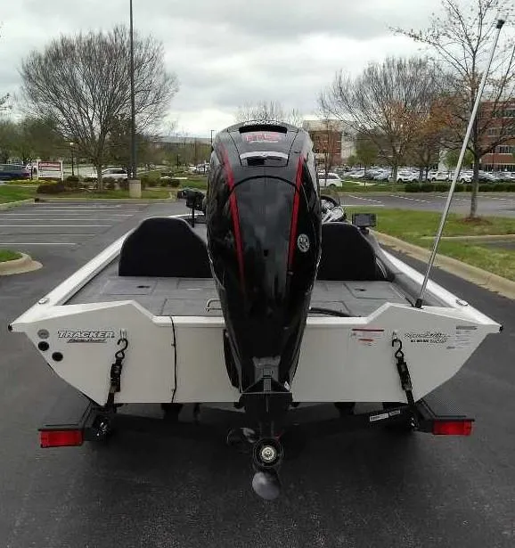 Slide: The Image of 2024 Tracker Pro Team 190 TX boat with outboard motor in parking lot. - 5