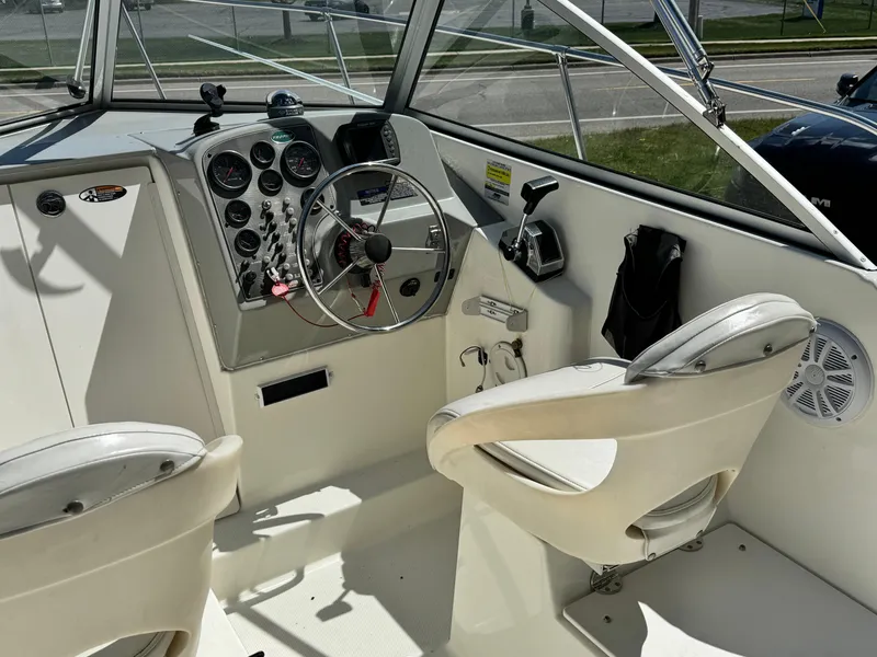 Slide: The Image of 2005 Trophy 1952 Walkaround boat cockpit with steering wheel and control panel. - 12