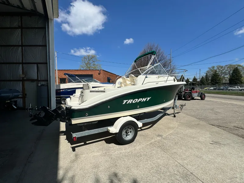Slide: The Image of 2005 Trophy 1952 Walkaround boat on a trailer outside a garage. - 2