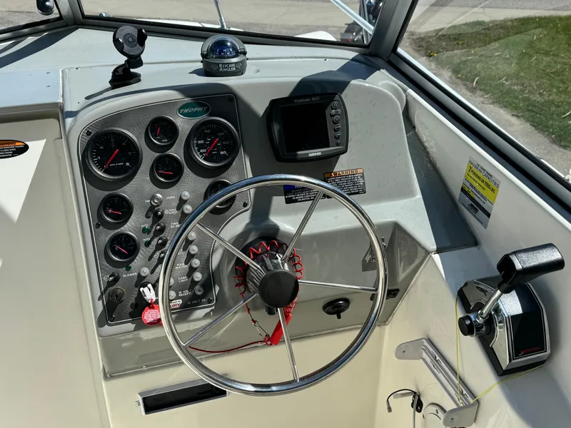 Slide: The Image of Dashboard of a 2005 Trophy 1952 Walkaround boat with steering wheel and gauges. - 29