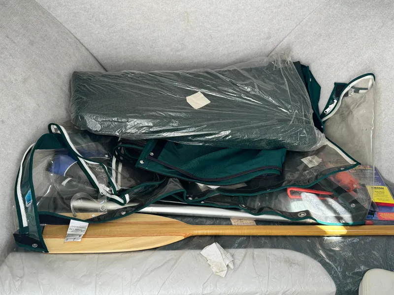 Slide: The Image of Boat storage compartment with paddles, gear, and equipment in a 2005 Trophy 1952 Walkaround. - 31