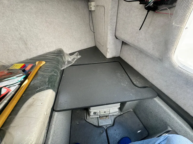 Slide: The Image of Interior cabin of a 2005 Trophy 1952 Walkaround boat with storage and seating. - 33