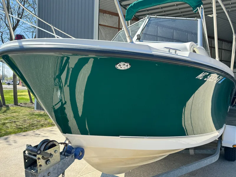 Slide: The Image of 2005 Trophy 1952 Walkaround boat on trailer, green hull, parked outside. - 6