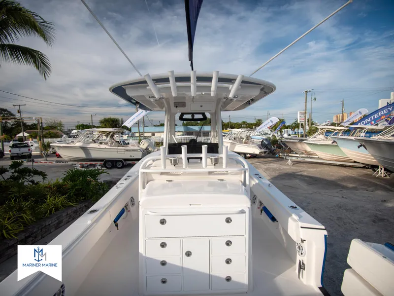 Slide: The Image of 2024 Regulator 31 boat interior at a marina, showcasing storage compartments and helm station. - 12