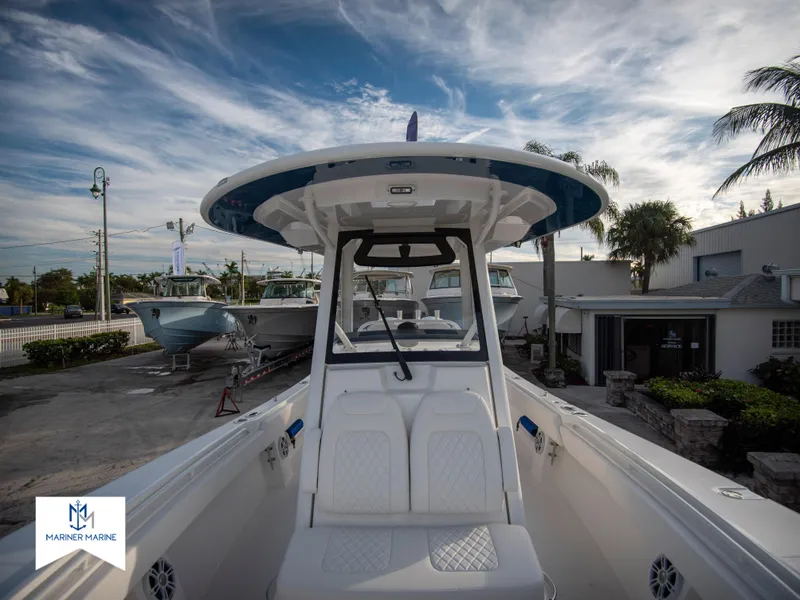 Slide: The Image of 2024 Regulator 31 boat at a marina under a blue sky. - 18