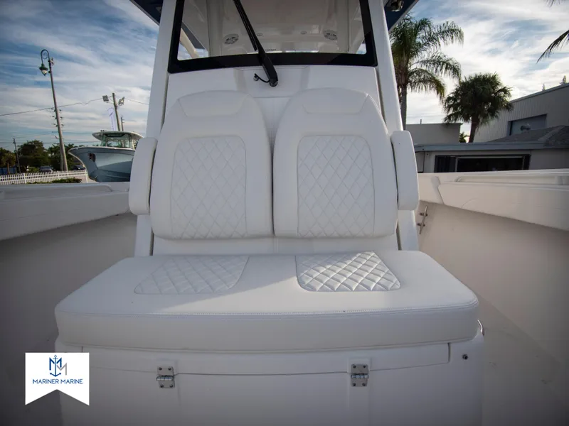 Slide: The Image of 2024 Regulator 31 boat with white cushioned seating and diamond stitching. - 19