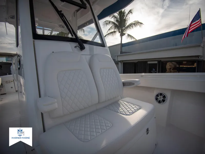 Slide: The Image of 2024 Regulator 31 boat with white cushioned seating and American flag in the background. - 20