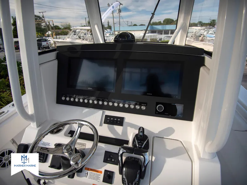 Slide: The Image of 2024 Regulator 31 boat dashboard with dual screens and steering wheel. - 22