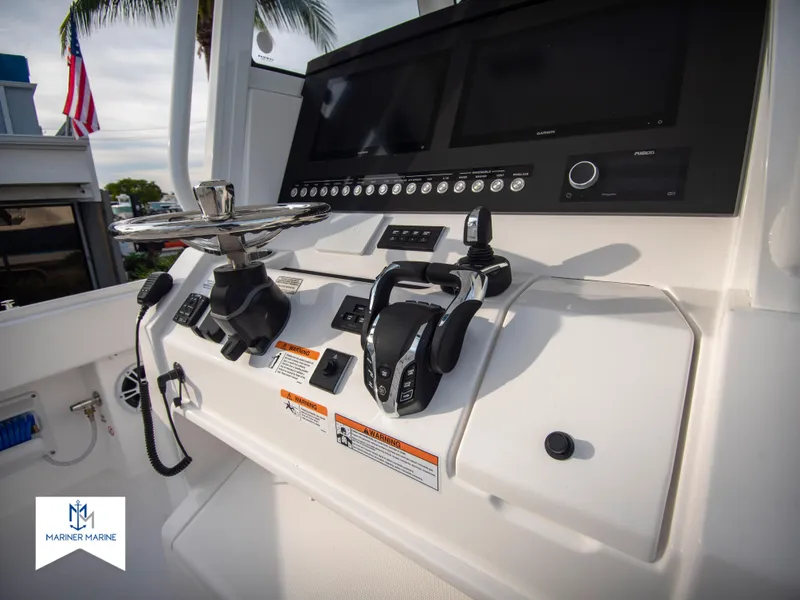 Slide: The Image of 2024 Regulator 31 boat control panel with dual screens and throttle controls. - 23