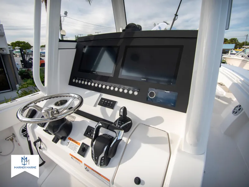 Slide: The Image of 2024 Regulator 31 boat dashboard with dual screens and control panel. - 24