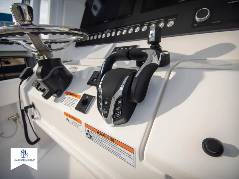 Slide: The Image of Close-up of 2024 Regulator 31 boat control panel and steering wheel. - 25