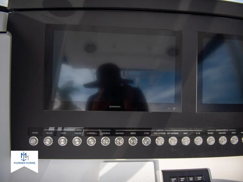 Slide: The Image of 2024 Regulator 31 boat dashboard with Garmin display and control buttons. - 26