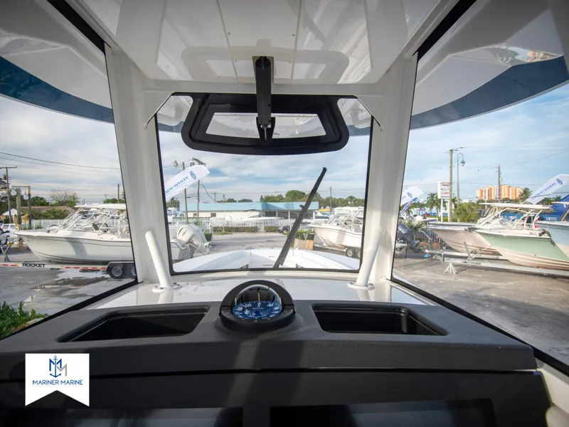 Slide: The Image of View from the helm of a 2024 Regulator 31 boat at a marina. - 28