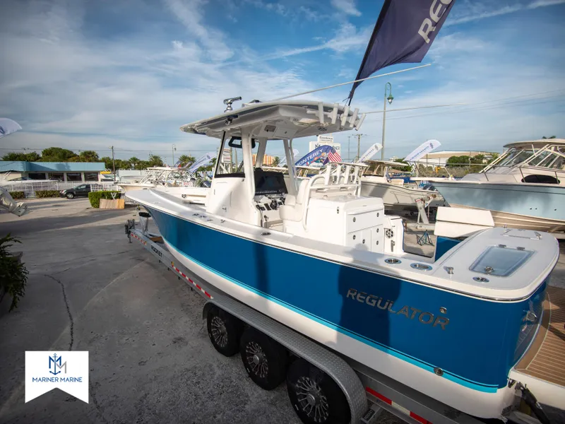 Slide: The Image of 2024 Regulator 31 boat on trailer at Mariner Marine dealership. - 3