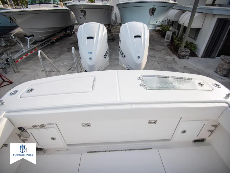 Slide: The Image of 2024 Regulator 31 boat with twin outboard engines at a marina. - 34