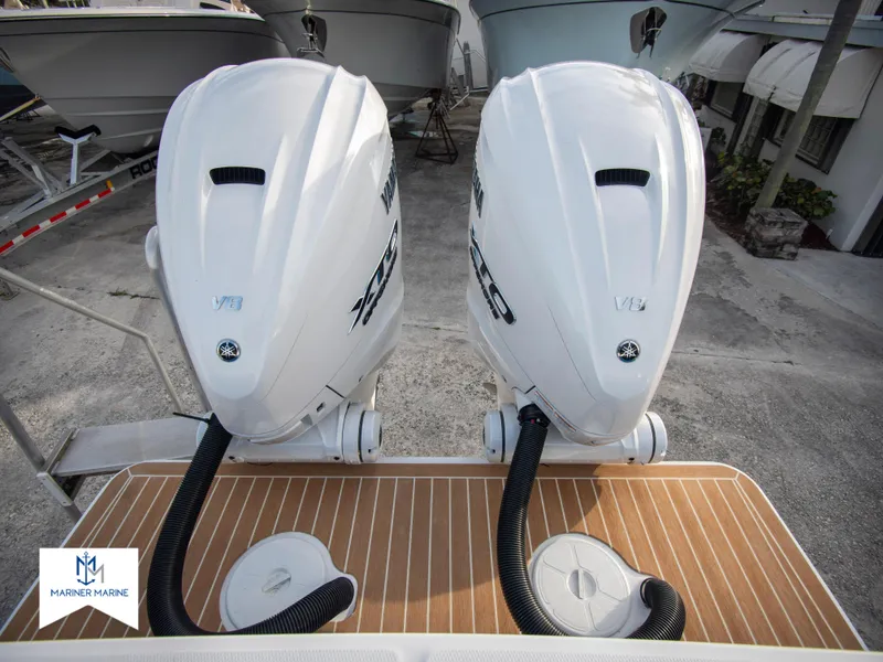 Slide: The Image of 2024 Regulator 31 boat with twin outboard engines at a marina. - 35