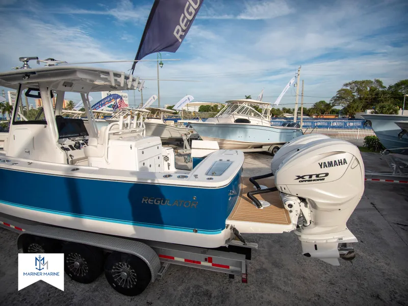 Slide: The Image of 2024 Regulator 31 boat with Yamaha XTO engine on trailer at marina. - 4