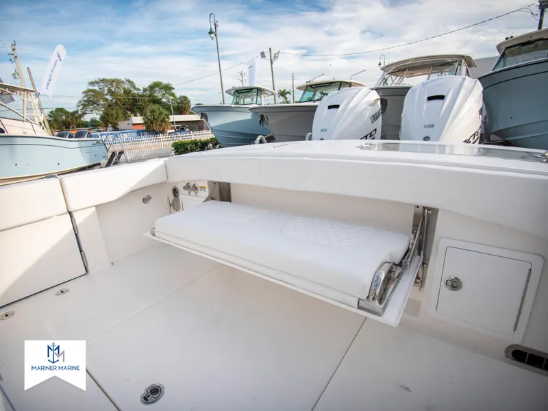 Slide: The Image of 2024 Regulator 31 boat with fold-down seating and twin outboard engines. - 42