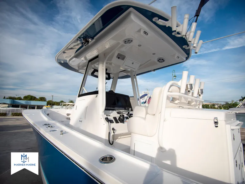 Slide: The Image of 2024 Regulator 31 boat with center console and fishing rod holders. - 5