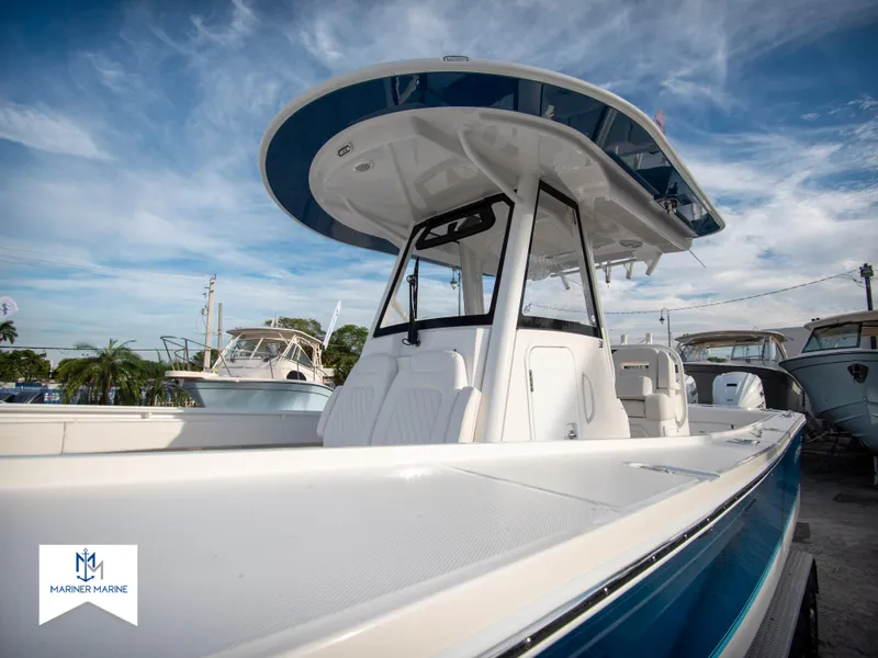Slide: The Image of 2024 Regulator 31 boat with T-top and sleek design, docked at a marina. - 6