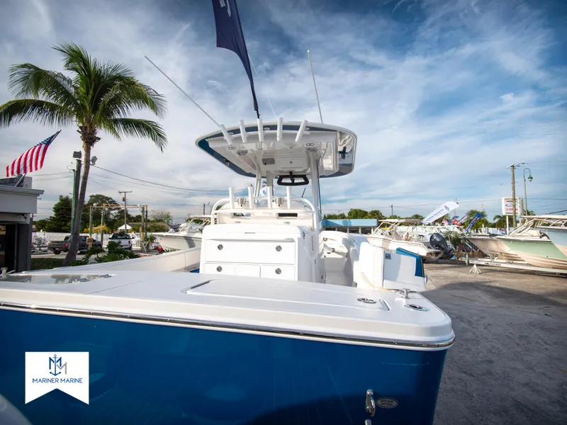 Slide: The Image of 2024 Regulator 31 boat at a marina with palm trees and American flag. - 8