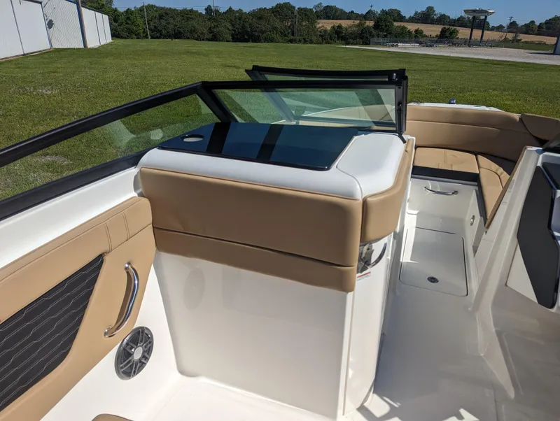 Slide: The Image of 2024 Sea Ray SPX 230 boat interior with tan and white seating. - 10