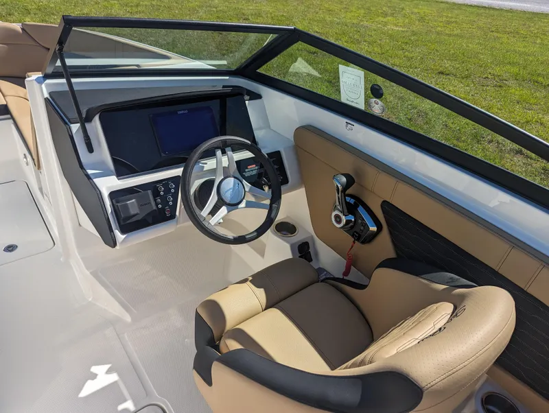 Slide: The Image of 2024 Sea Ray SPX 230 boat cockpit with steering wheel and control panel. - 12