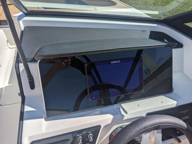 Slide: The Image of 2024 Sea Ray SPX 230 dashboard with Simrad display. - 14